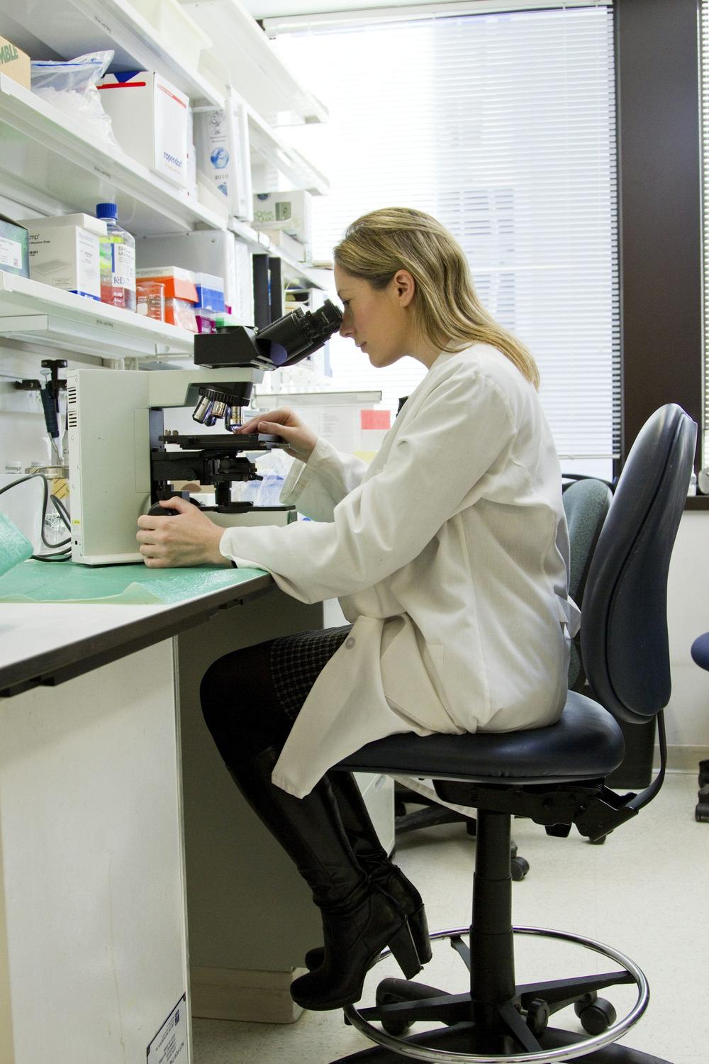 A technician focused on microscope work