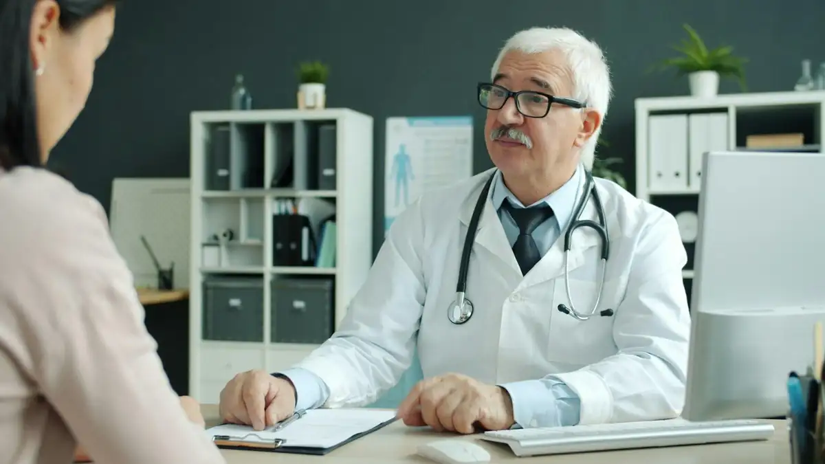Doctor consulting with a patient before referring them for lab tests
